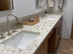Gilasi Surfaces recycled glass countertop in Tosoro- Redrock Tileworks backsplash color Fog