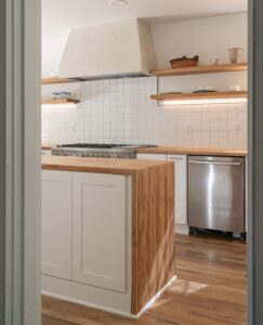 Sustainable Northwest Wood Tanoak butcher block- Fireclay tile backsplash- American Clay plaster range hood- Photo by Logan Havens