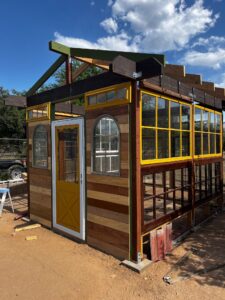 Custom green house made from salvaged windows and doors